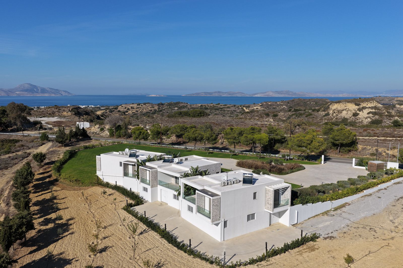 The villas on their hillside with the Aegean and the islands beyond