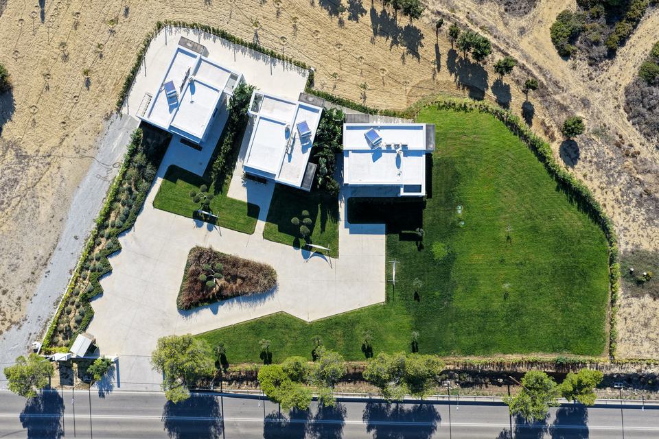 The three villas straight from above, around the triangular planted garden